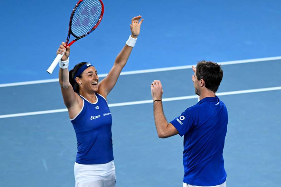 France's Caroline Garcia (L) and Edouard Roger-Vasselin celebrate their doubles victory