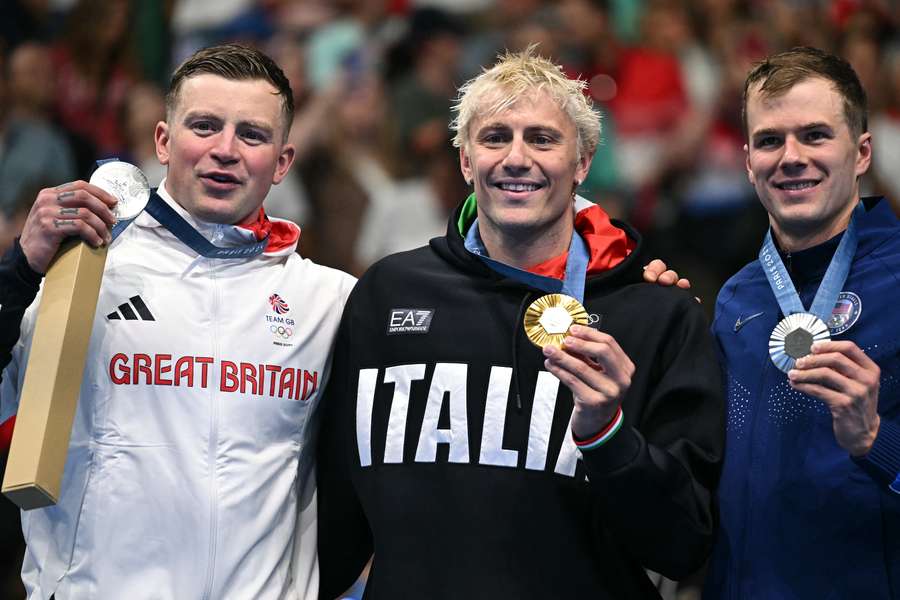 Silver medallist Britain's Adam Peaty, gold medallist Italy's Nicolo Martinenghi and silver medallist US' Nic Fink stand on the podium