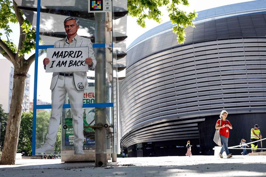 A mural depicting Jose Mourinho stands in front of the Santiago Bernabeu stadium