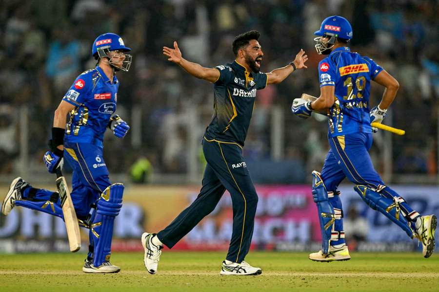 Gujarat Titans' Mohammed Siraj (centre) celebrates after their win over Mumbai Indians