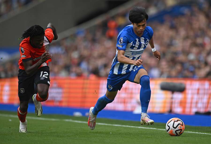 Luton Town's Burkinese defender #12 Issa Kabore runs after Brighton's Japanese midfielder #22 Kaoru Mitoma Luton Town's Burkinese defender #12 Issa Kabore runs after Brighton's Japanese midfielder #22 Kaoru Mitoma
