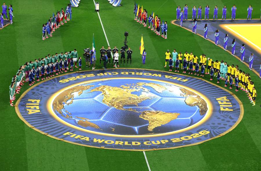 Players line up during the national anthems before the match. Players line up during the national anthems before the match.