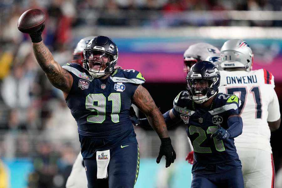 Seahawks' Byron Murphy II (91) celebrates with cornerback Devon Witherspoon (21) during Super Bowl LX