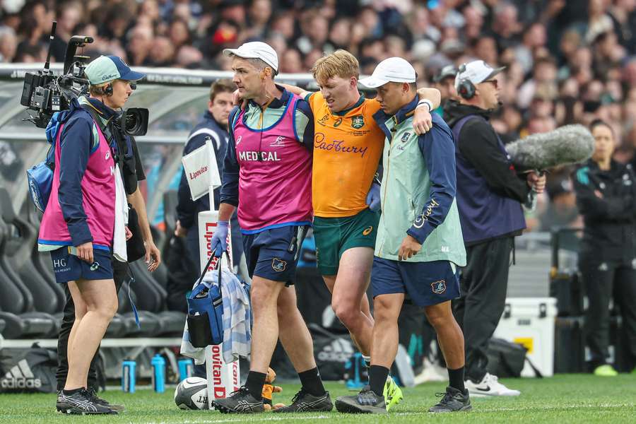 Tate McDermott is assisted off the Eden Park pitch on Saturday evening.