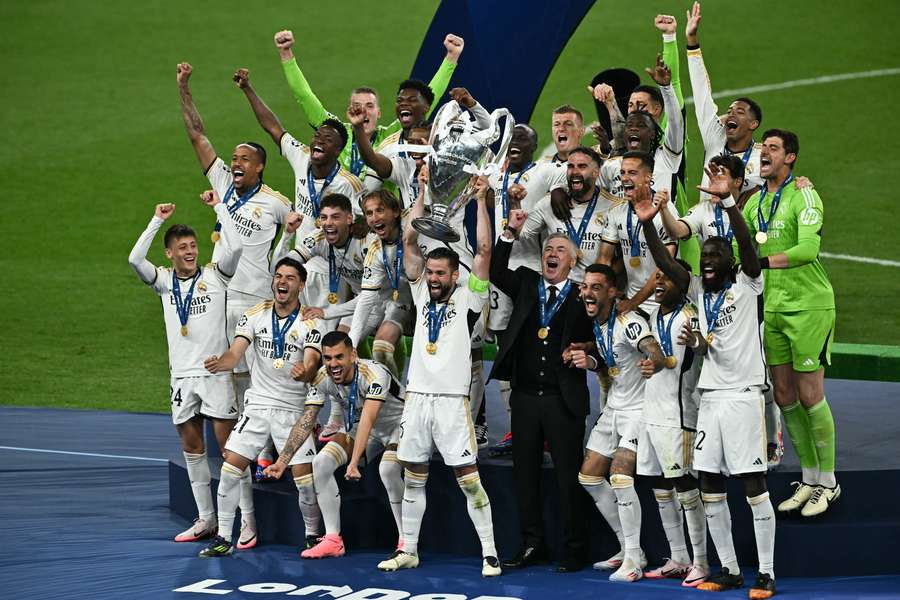 Real Madrid's Spanish defender #06 Nacho Fernandez lifts the trophy