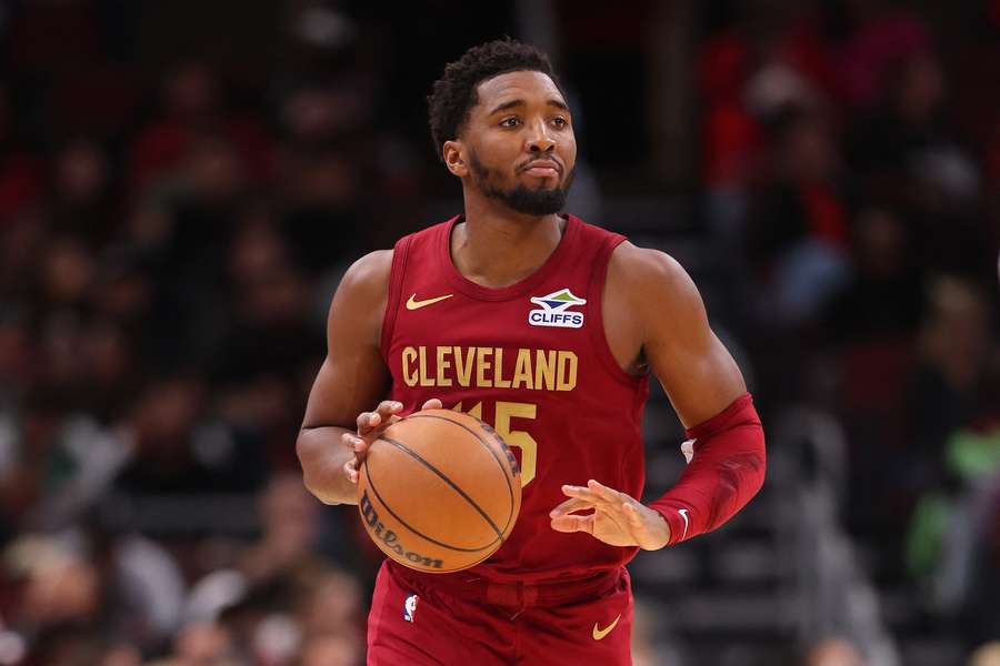 Cleveland Cavaliers guard Donovan Mitchell bringing the ball up the court mid-game.