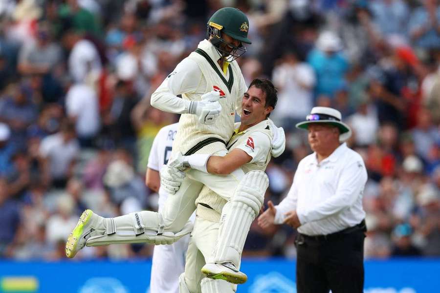 Pat Cummins and Nathan Lyon celebrate after winning the first test