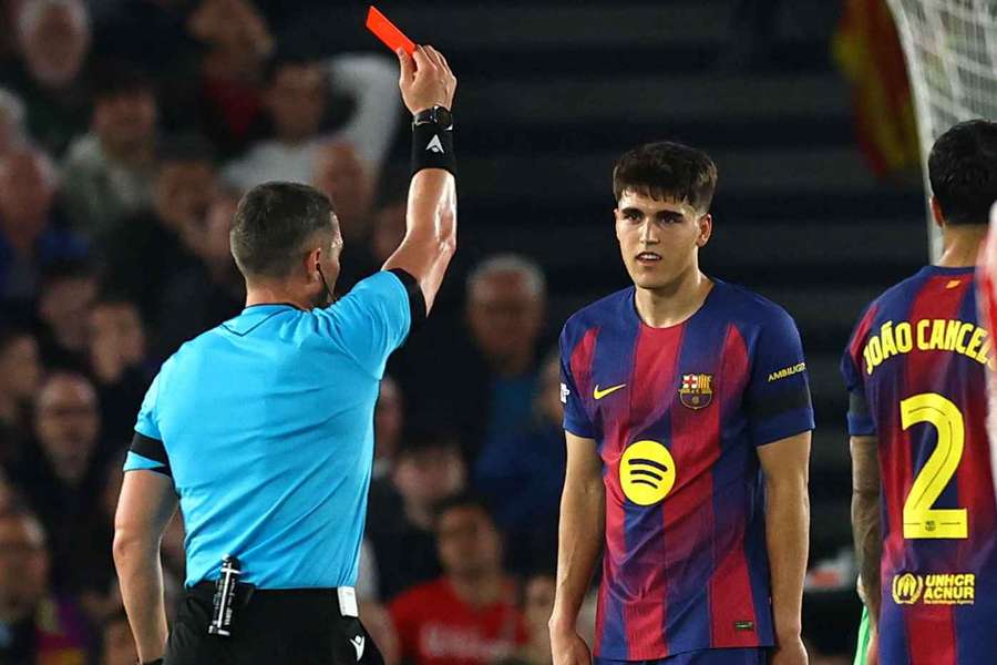 Barcelona's Pau Cubarsi is shown a red card by referee Istvan Kovacs during the loss to Atletico Madrid