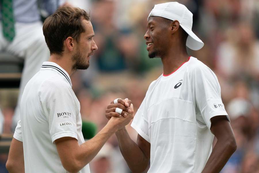 Medvedev and Eubanks shake hands at the net after the match