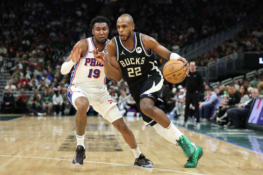 Khris Middleton of the Milwaukee Bucks drives around Justin Edwards of the Philadelphia 76ers