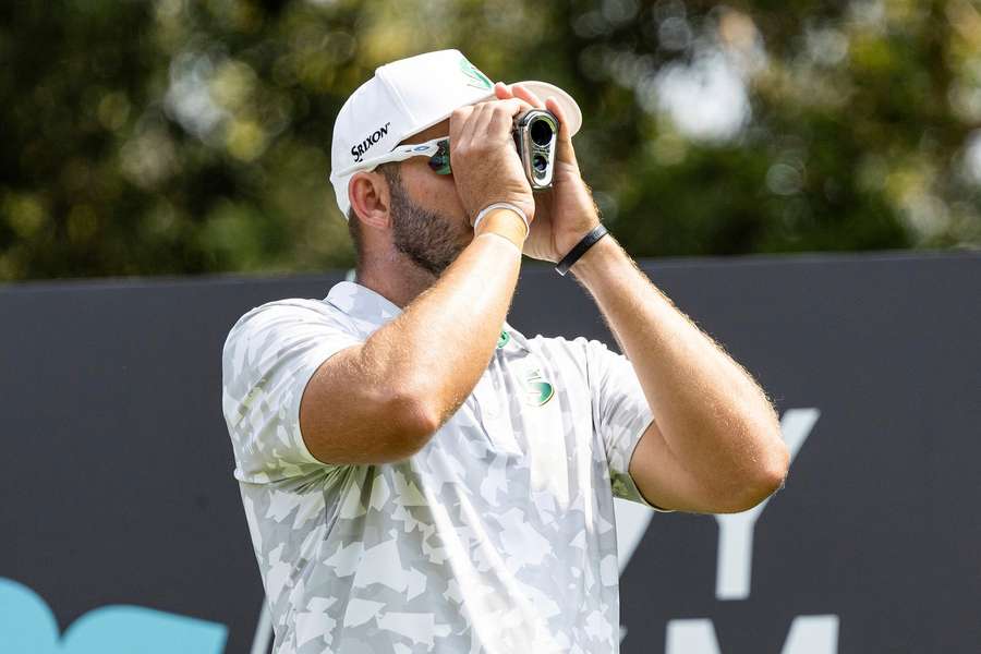 Burmester checks his yardage in Hong Kong