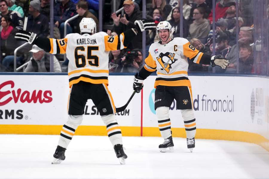 Erik Karlsson celebrates with Sidney Crosby (right) after scoring a game-winning goal