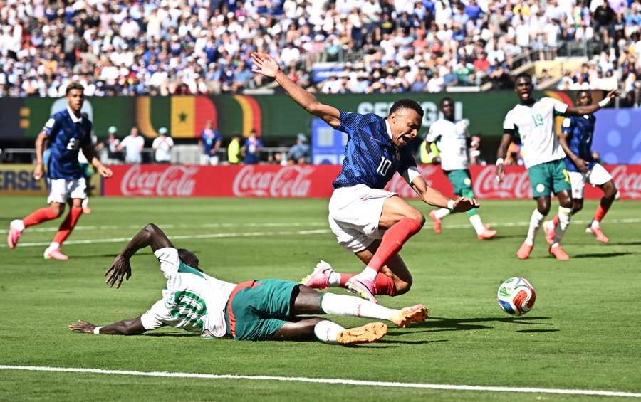 Senegal's Sadio Mane challenges France's Kylian Mbappe in the penalty area leading to a VAR review Senegal's Sadio Mane challenges France's Kylian Mbappe in the penalty area leading to a VAR review