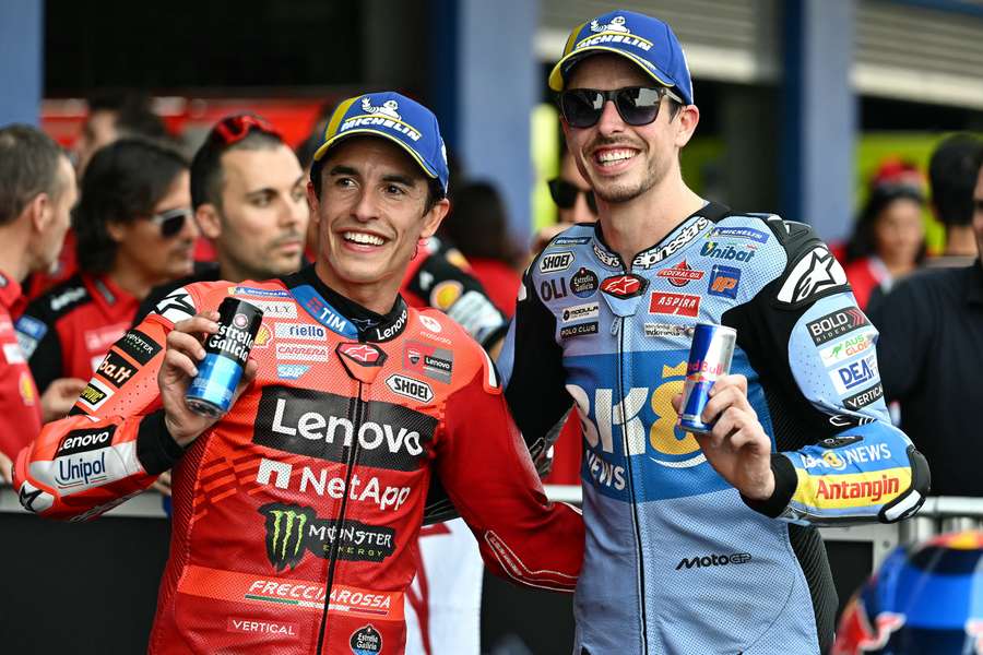 First-place qualifier Marc Marquez stands with his brother and second-place qualifier Alex Marquez