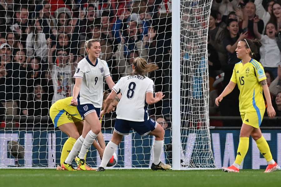 England's forward #09 Alessia Russo (2L) celebrates with England's midfielder #08 Georgia Stanway (C) after scoring England's first goal