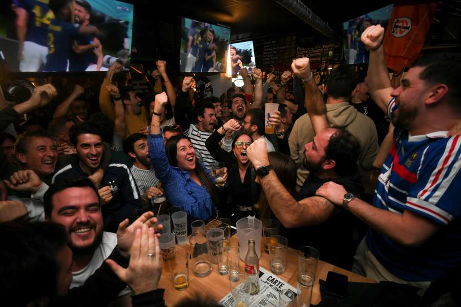 France supporters celebrate their quarter-final win in a bar in Toulouse.