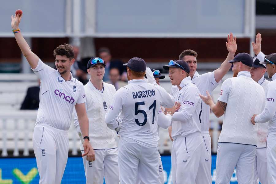 Josh Tongue raises the ball aloft to commemorate his five wickets