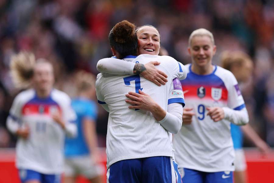 Lucy Bronze (right) celebrates for England