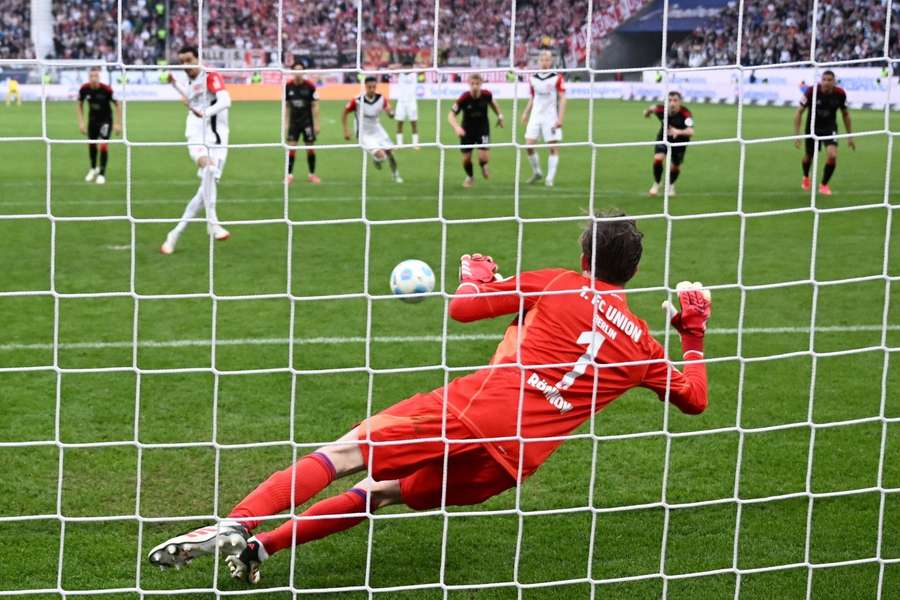 Frederik Ronnow saves a penalty from Eintracht Frankfurt's Hugo Ekitike