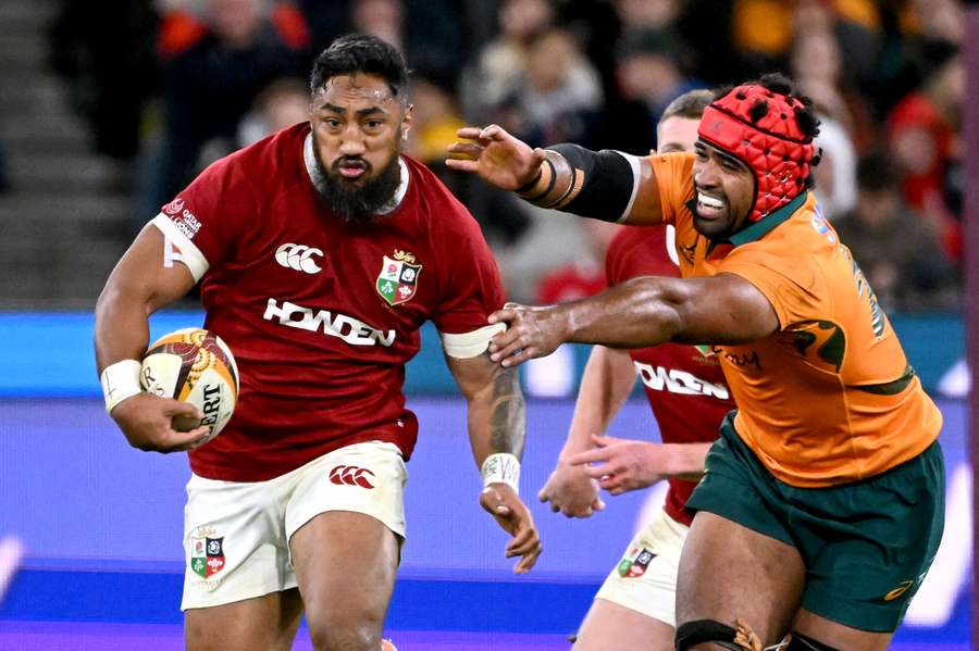British and Irish Lions’ Bundee Aki (left) runs away from Australia’s Langi Gleeson