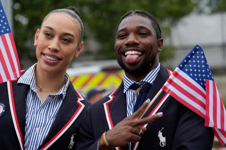 Noah Lyles of the United States poses for photos while travelling along the Seine River