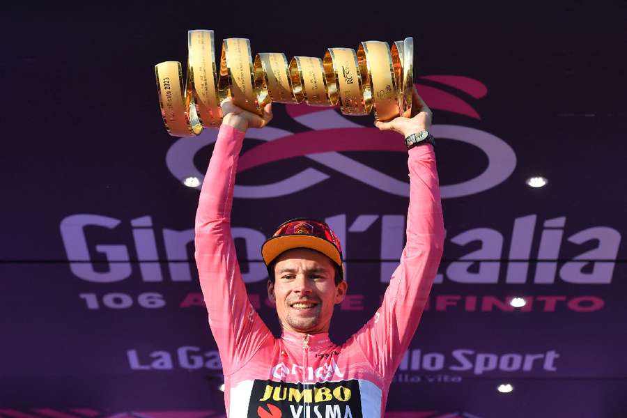 Primoz Roglic celebrates on the podium with the trophy after winning the Giro d'Italia