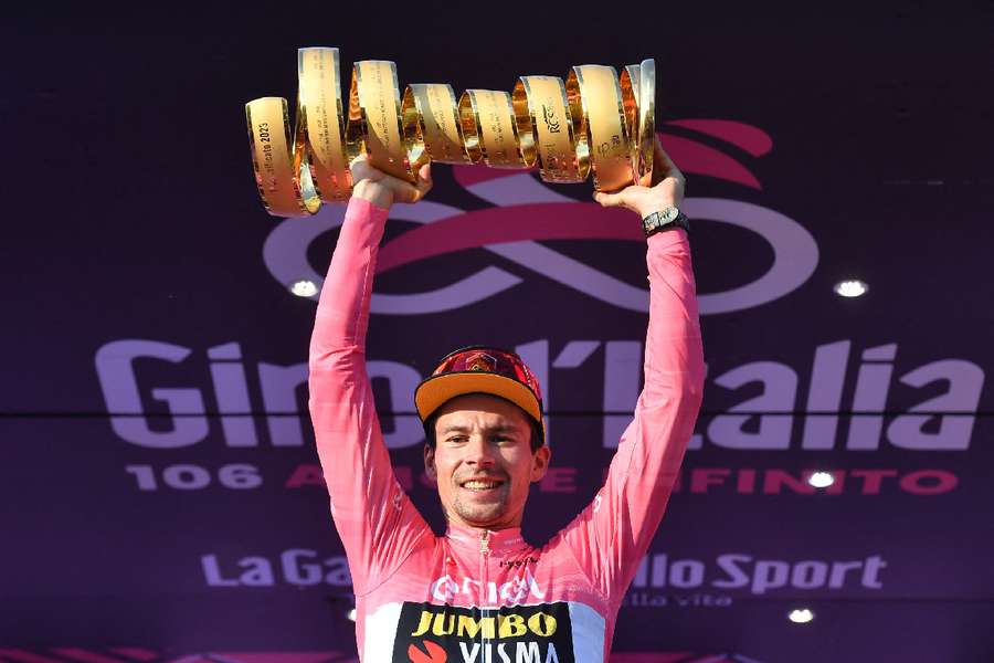 Primoz Roglic celebrates on the podium with the trophy after winning the Giro d'Italia