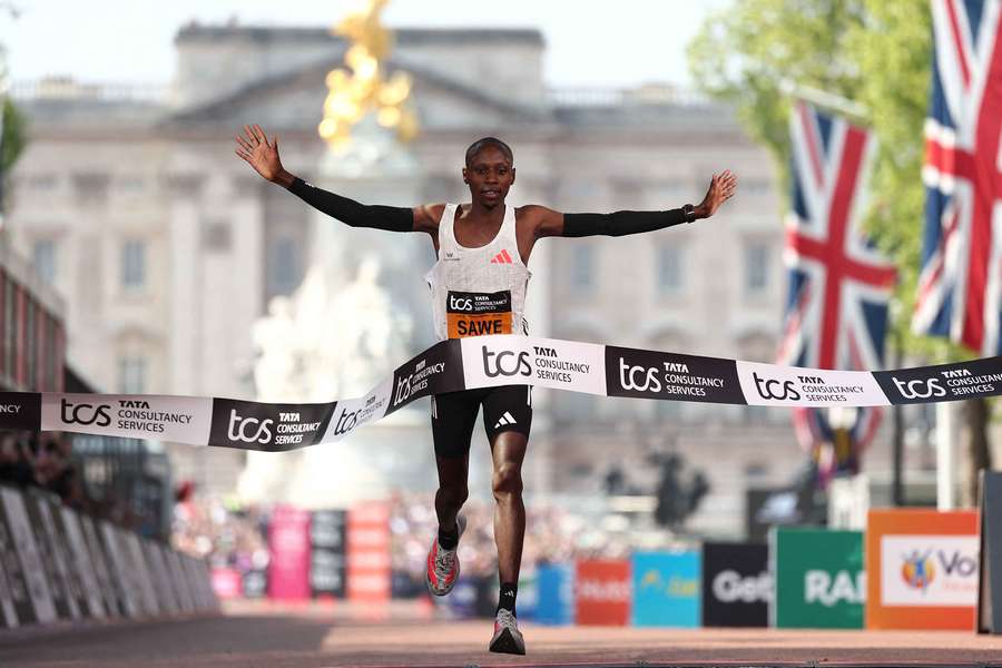 First placed Sabastian Sawe of Team Kenya celebrates as he crosses the finish line