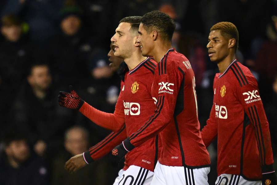 Manchester United's Portuguese defender #20 Diogo Dalot (2L) celebrates with teammates