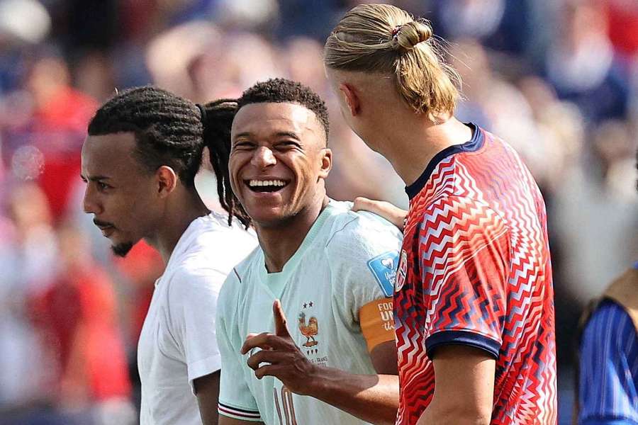 Kylian Mbappe and Erling Haaland share a laugh after the 4-1 result.