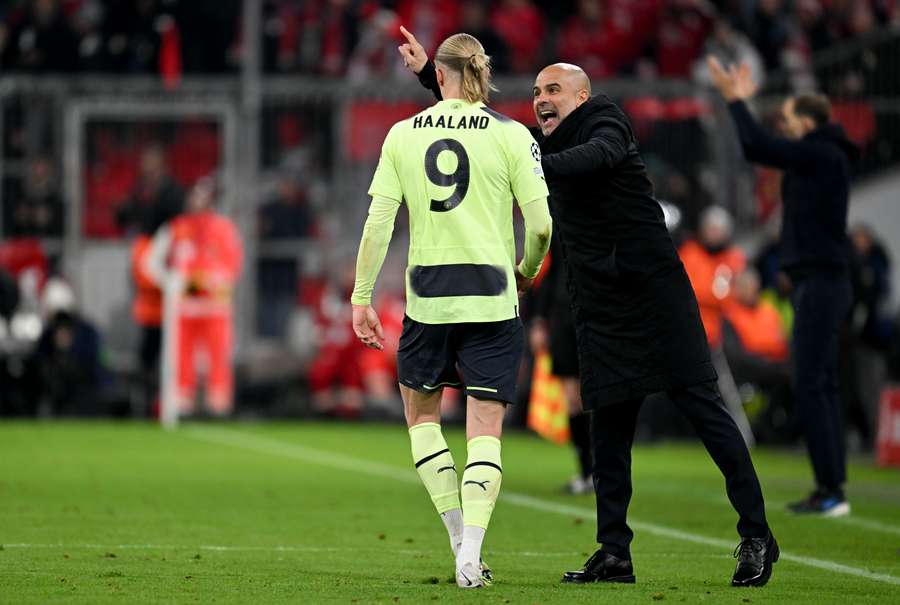 Manchester City's Spanish manager Pep Guardiola gives instructions to Norwegian striker Erling Haaland