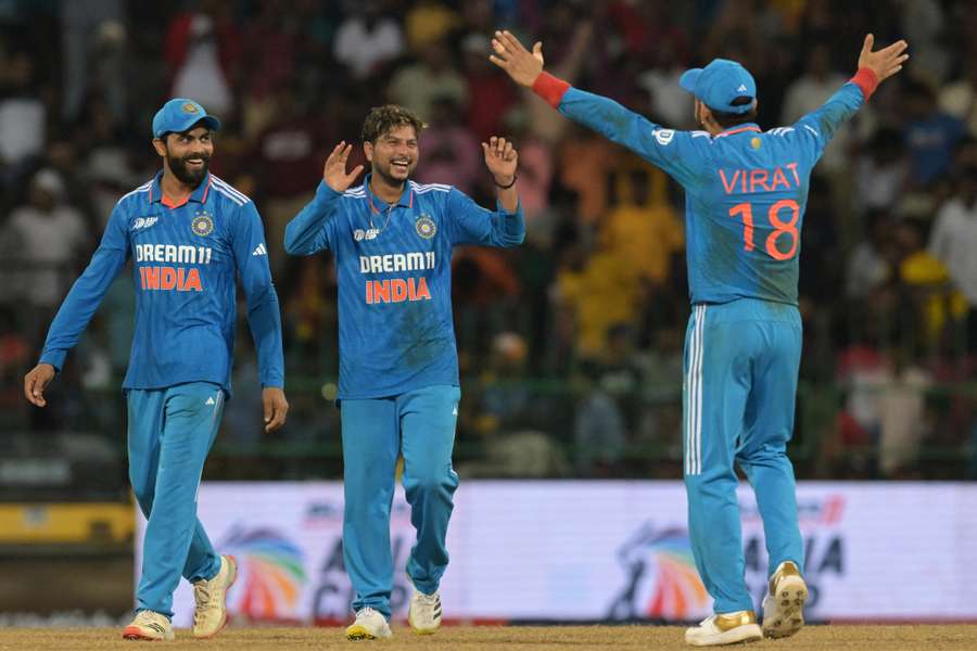 India's Kuldeep Yadav (C) celebrates with Virat Kohli (R)