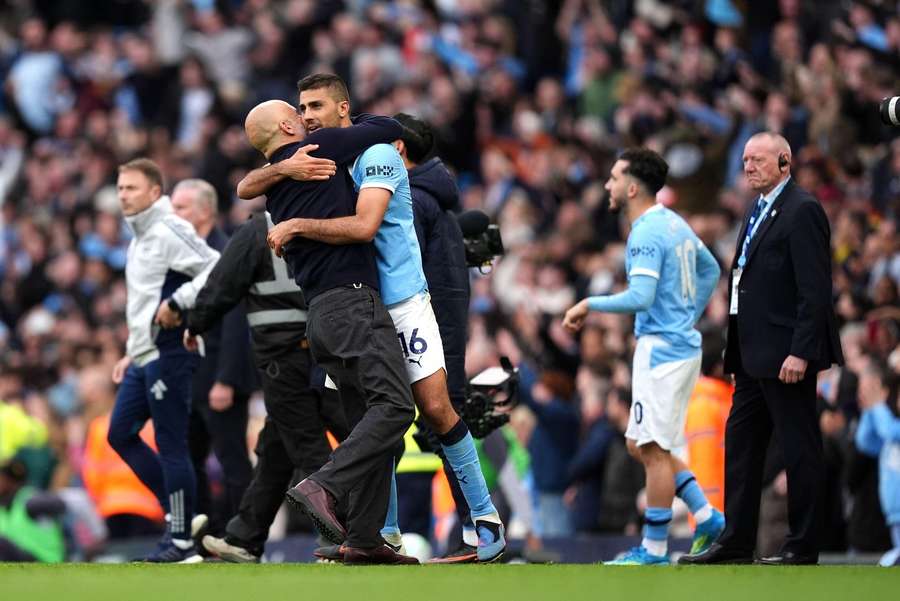 Rodri and Guardiola embrace after beating Arsenal