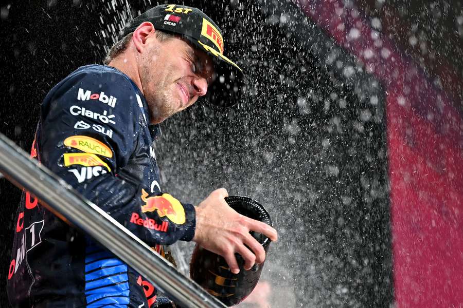 Red Bull Racing's Dutch driver Max Verstappen celebrates at the podium after the Qatari Formula 1 Grand Prix