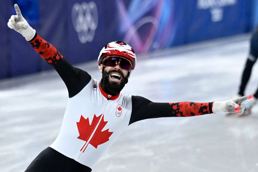 Canada's Steven Dubois celebrates winning the gold medal at the 500m