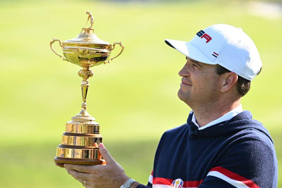 Zach Johnson poses with the Ryder Cup trophy, but his US team will need to create history in order to win on Sunday