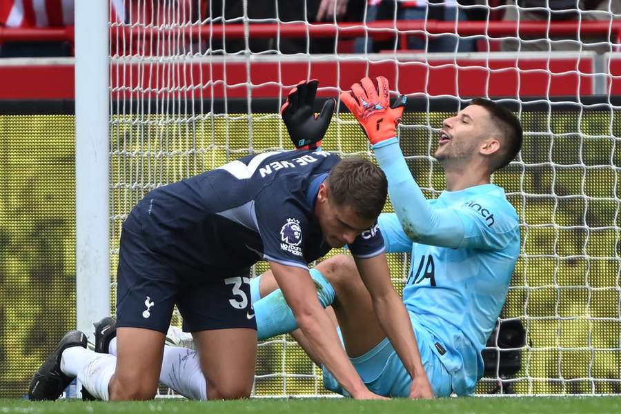 Tottenham Hotspur's Italian goalkeeper #13 Guglielmo Vicario (R) and Dutch defender #37 Micky van de Ven (L) react after conceding