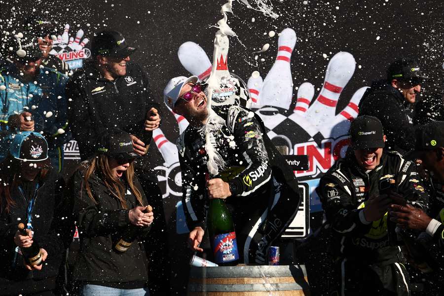 Shane van Gisbergen pops the champagne after his NASCAR victory on Monday morning. 