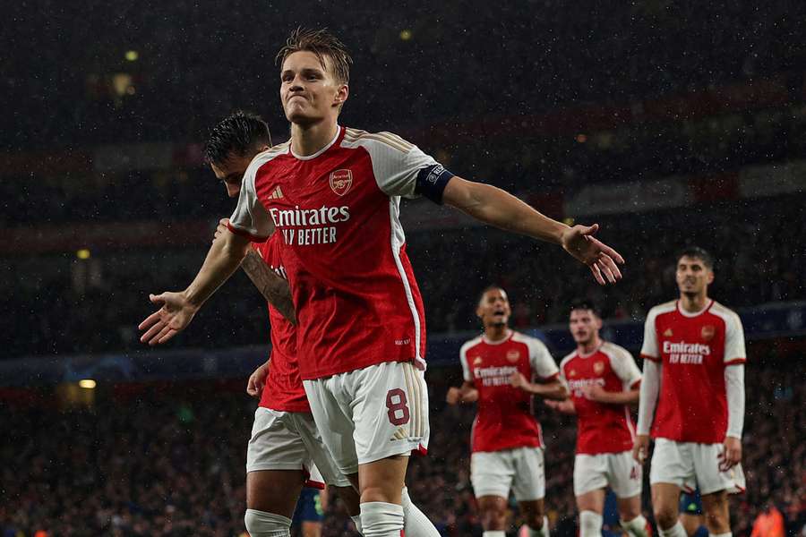 Arsenal captain Martin Odegaard celebrates scoring their fourth goal against PSV