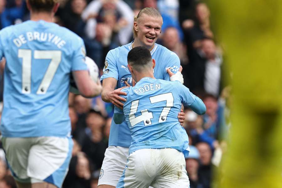 Erling Haaland (C) celebrates with Manchester City's English midfielder #47 Phil Foden after scoring his fourth