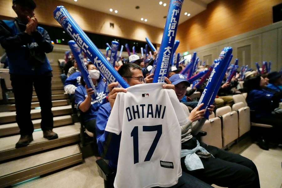 People watch a live stream of Game 3 of the baseball World Series at a public viewing event in Oshu