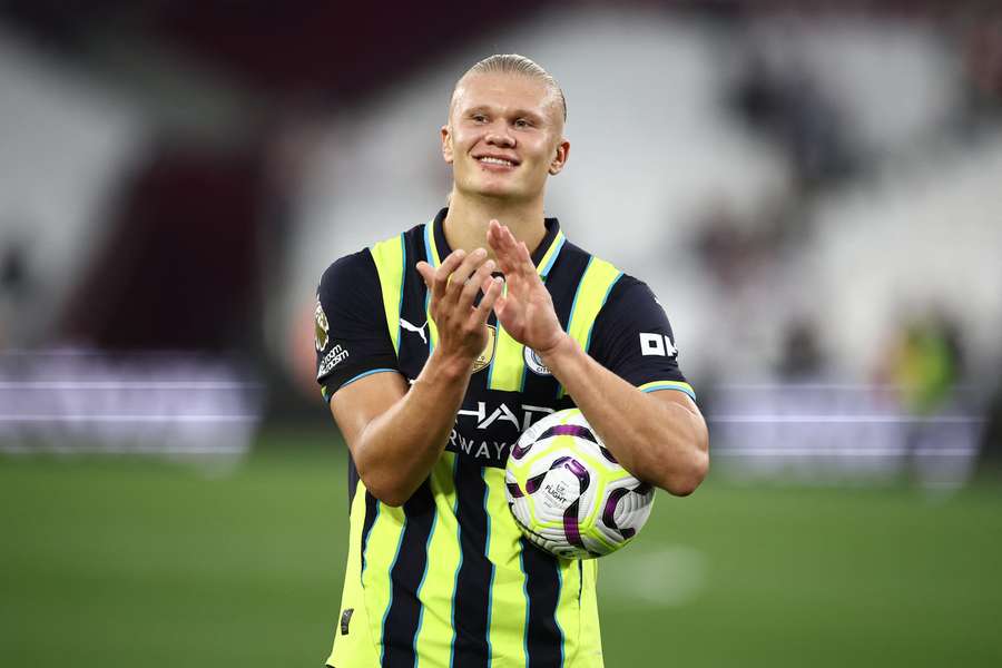 Erling Haaland poses with the match ball after scoring a hat-trick against West Ham