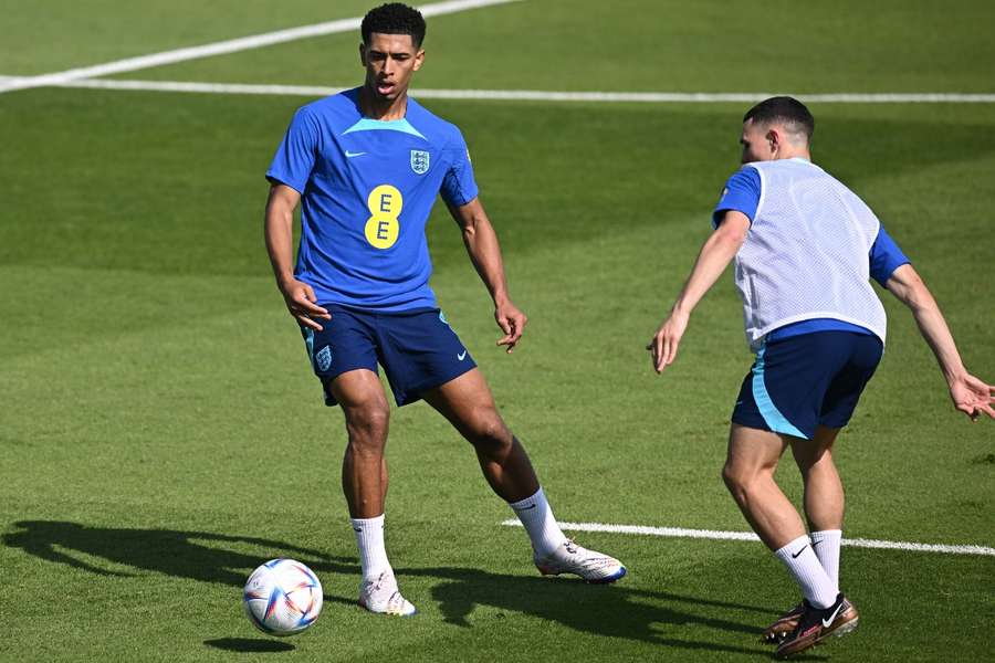 Jude Bellingham (L) takes on Phil Foden in England training