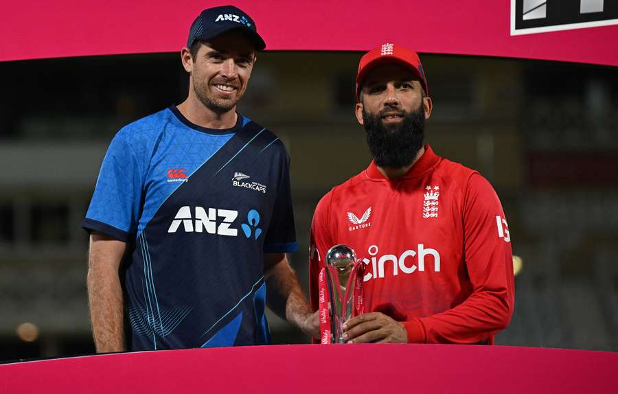 New Zealand's Tim Southee (L) and England's Moeen Ali pose with the trophy after the fourth T20 international cricket match between England and New Zealand