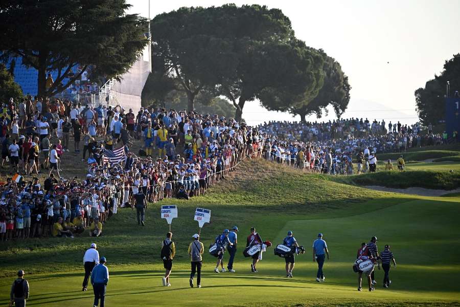 The players walk across the course at the Ryder Cup