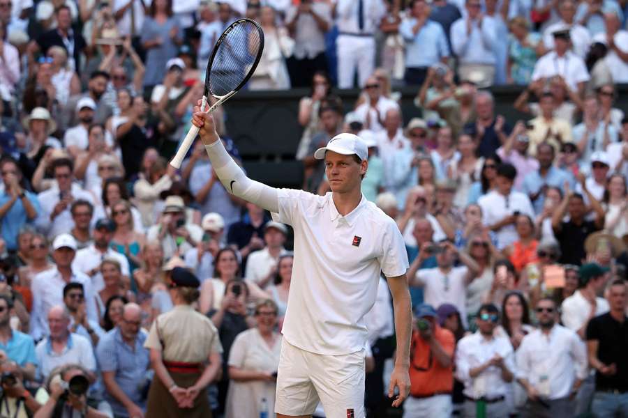 Jannik Sinner celebrates winning his semi-final match against Novak Djokovic 