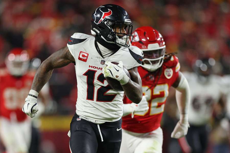 Nico Collins of the Houston Texans carries the ball past Nick Bolton of the Kansas City Chiefs Nico Collins of the Houston Texans carries the ball past Nick Bolton of the Kansas City Chiefs