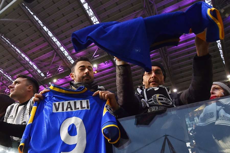 A Juventus fan displays a shirt with former Juventus player Gianluca Vialli's name