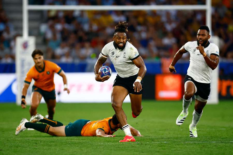 Fiji's Waisea Nayacalevu carries the ball past a tackle against Australia