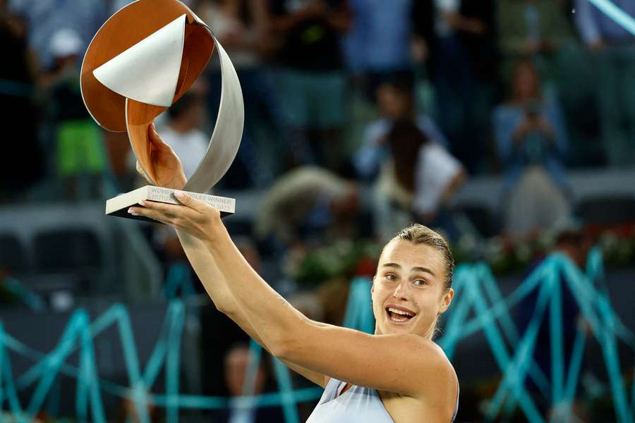Aryna Sabalenka lifts the winner's trophy in the Spanish capital